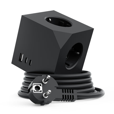 A black 3-in-1 power adapter cube with built-in USB-A and USB-C ports on one face and two European-style AC outlets on another, shown with its coiled black power cord and UK plug on a white background.