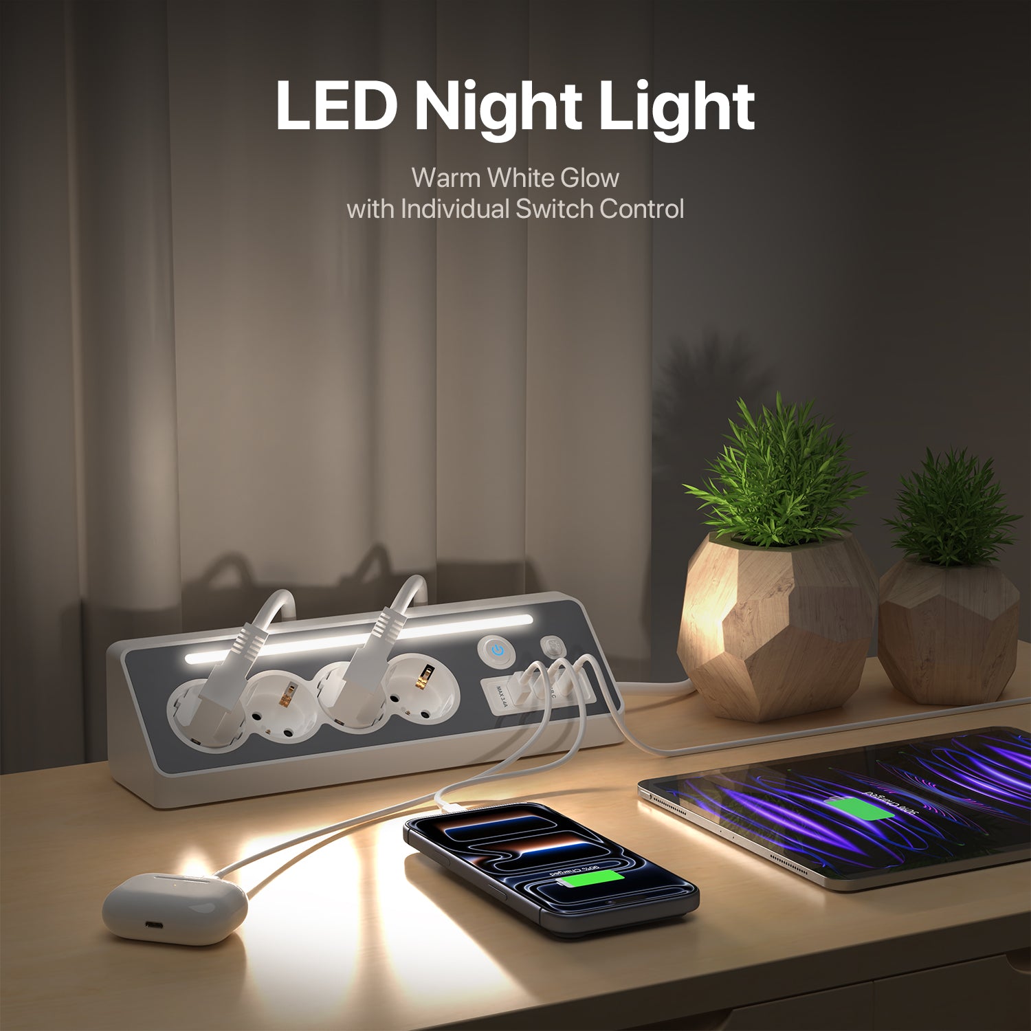 A desktop power strip with integrated LED night lighting shown on a wooden table, with a smartphone and earbud case charging under warm white light. Text at the top reads 'LED Night Light' and 'Warm White Glow with Individual Switch Control.